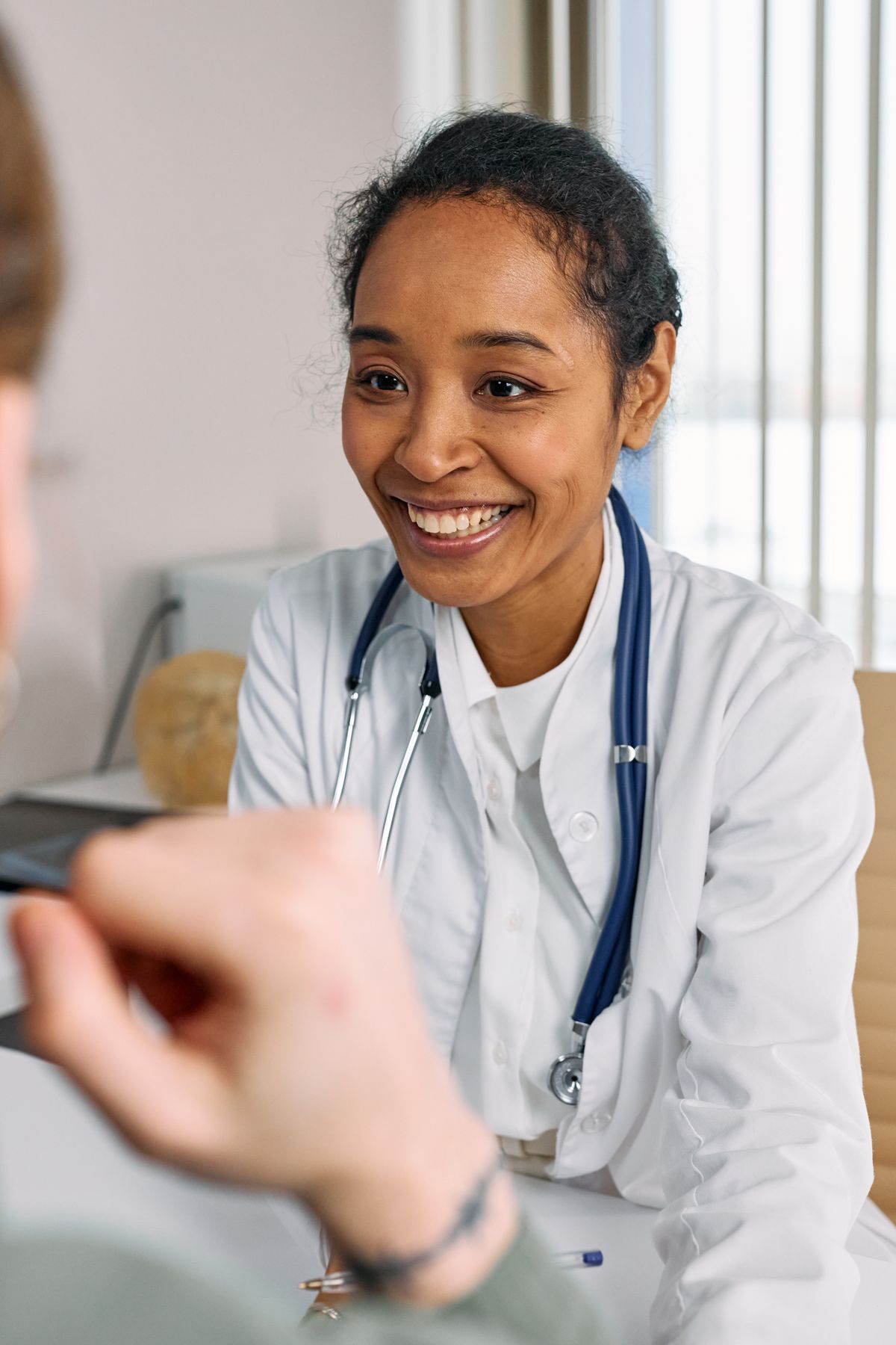 Physician offering a warm preventive care consultation